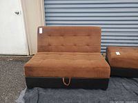 Front view of armless futon in upright position showing tufted brown microfiber upholstery