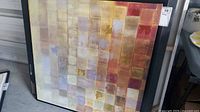 Full view of framed abstract canvas showing grid pattern and colors