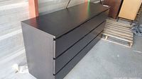 Front view of dark brown six-drawer dresser