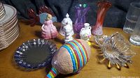 Group shot of all figurines, vases, glass pieces and ceramic armadillo