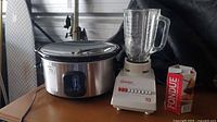 Slow cooker, blender, fondue mix on table