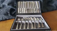 Open box showing full 12-place flatware set