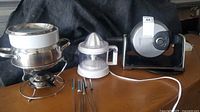 Group view: fondue set, citrus juicer, waffle maker, forks