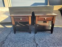 Front view of both end tables showing drawer fronts and lower shelves