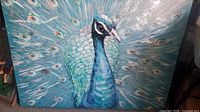 Full view of peacock painting showing subject, colors, texture and overall condition