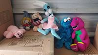 Group shot of all six plush toys on boxes