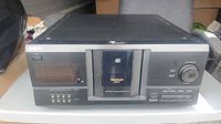 Front view showing Sony CDP-CX220 unit with controls and disc door