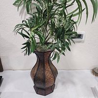 Full view of faux plant and decorative vase