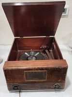 Lid open showing record player and tone arm