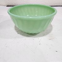 side view of green ribbed jadeite bowl