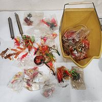 Overview of bucket, assorted lures in bags, two sinkers