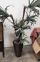 Full view of faux palm and patterned planter