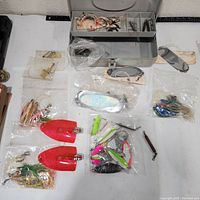 Overview of tackle box and assorted lures laid out