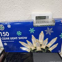 Boxed Trim A Home 150 Clear Light Show lights with snowflake graphics