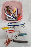 Top view of bin filled with assorted metal spoon lures