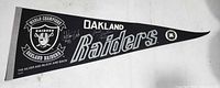 Full view of black and silver Oakland Raiders pennant