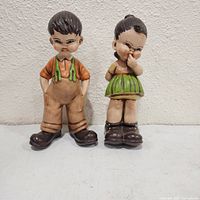 Front view of both figurines standing side by side