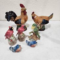 Front view of all seven ceramic bird figurines
