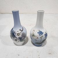 Front view of both Royal Copenhagen bud vases showing floral designs