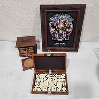 All items together: framed puzzle art, open domino case showing tiles, coaster box with coasters