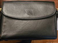 Front view of black pebbled leather Burberry crossbody bag