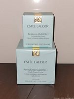 Both Estee Lauder cream boxes front view