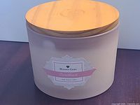 Front view of candle showing label and lid