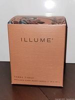 Front of Illume Terra Tabac candle box