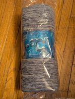 Rolled Luxear cooling blanket sealed in plastic