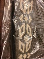 Toque detail showing geometric knit pattern through plastic