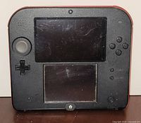 Front view of Nintendo 2DS powered off displaying wear and scratches