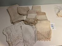 Top view of assorted vintage linens showing lace, crochet and plain pieces