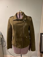 Front view of Dex army green faux suede moto jacket on dress form