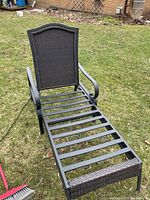 Chaise lounge frame showing metal slats, wicker back panel and armrests