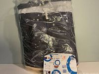 Sealed package showing folded bathtub with celestial pattern