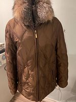 Front view showing quilted pattern, zipper, pockets, fur collar