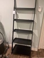 Front view of 5-tier black ladder shelf