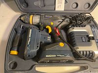 Drill, two batteries, charger, side handle and carrying case shown