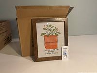 Front view of one wood frame with display insert, box behind