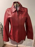 Front view of red leather jacket on mannequin