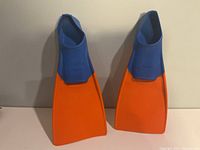 Front view of both blue and orange swim fins