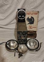 Group shot showing clock on stand, electronics unit, three vehicle lights