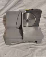 Front view of Bravetti meat slicer showing blade and carriage