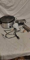 Group shot: Bravetti slow cooker, pasta roller, cutter, crank, clamp, clip lamp