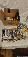 Box with loose stack of assorted video game magazines