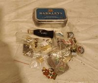 Overall lot showing Barkleys tin, mini Coca-Cola bottle and bagged enamel pins