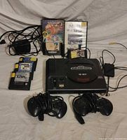 Group shot of console, controllers, cartridges, cases, cables