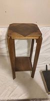 Front view of solid oak mission-style side table showing square top, legs, lower shelf