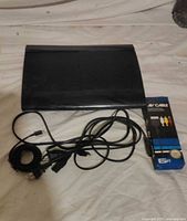 PlayStation 3 console with cords and boxed AV cable