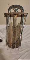 Front view of full wood and steel sled hanging vertically